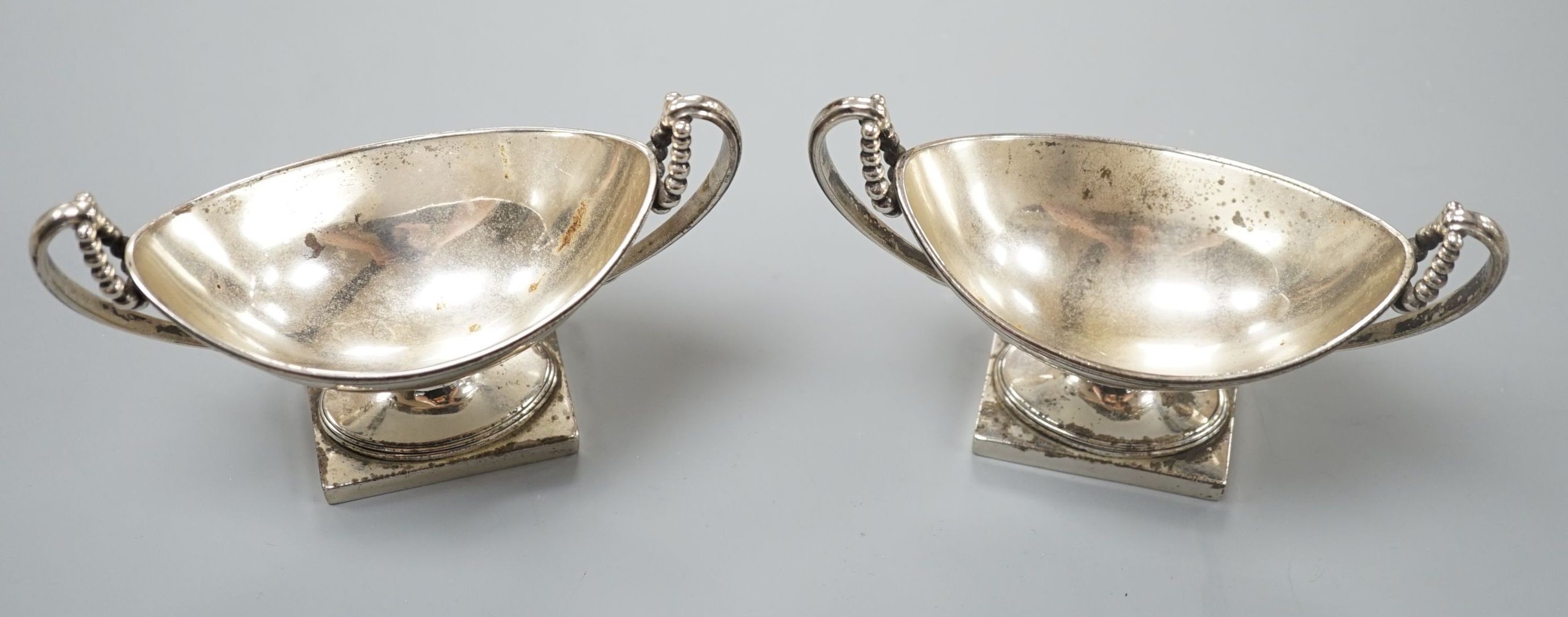 A pair of George III silver boat shaped two handled pedestal salts, Peter Podio, London, 1798, width 31.2cm, 8.5oz.